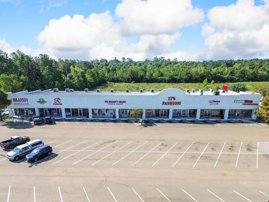 Tangi Plaza: Walmart-Shadowed Retail in a Highly-Visible Corridor